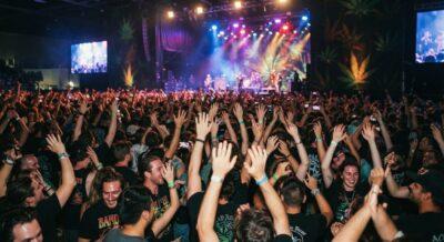 Concert crowd enjoying live music under stage lights – ideal setting for the best strain for concerts